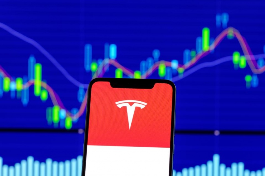 Tesla Motors logo is seen on an android smartphone over